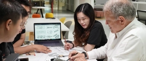 Pergola design team discussing sketches and prototypes during a collaborative brainstorming session