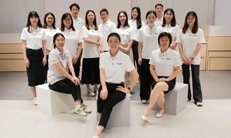 design-support-team-group-photo-2 Cross-functional company team posing for a group photo