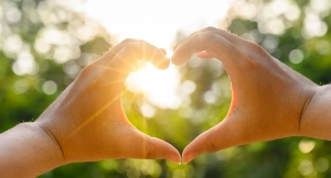 Hands forming a heart shape symbolizing care and corporate social responsibility