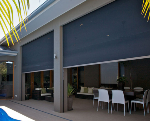 Motorized Zip Track Zipblind outdoor shade screens over modern home patio dining space