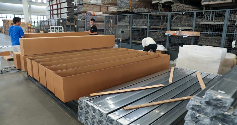 Aluminum pergola kits being loaded into a shipping container in China