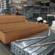 Aluminum pergola kits being loaded into a shipping container in China
