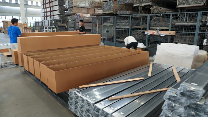 Aluminum pergola kits being loaded into a shipping container in China